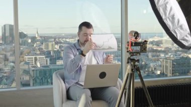 Man making business video blog. Vlogger finance advisor management information. Happy young social media blogger man, making videos for vlog