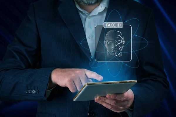 Man using tablet with face id scan and modern technology. Login using Face id and AI. Network security, digital banking, financial technology, online payment. Smart devices security
