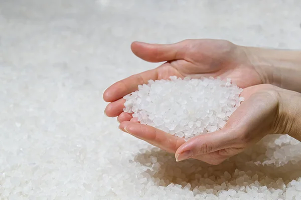 sea salt heap in hands. Rock salt, salt flakes, Nin, Croatia. Nature sea Salt works
