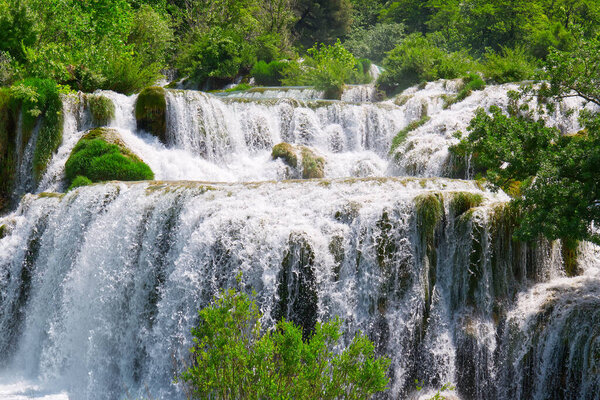 Beautiful Waterfall background in sunny summer day. Beautiful Waterfall In Krka National Park - Croatia, Europe. Krka river waterfalls in the Krka National Park