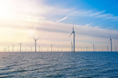 Kıyıdan uzak yel değirmeni çiftliği. Hollanda 'nın güzel ve aydınlık bir gününde yel değirmenleri denizde izole edildi. Yeşil enerji Flevoland küresel ısınma yel değirmenleriyle yenilenebilir enerji