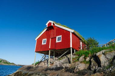 Norway. Fishermans red rorbu cottage in the Lofoten Islands. Typical Scandinavian Fishermans house. now days popular tourist apartments, cottages, rent houses.
