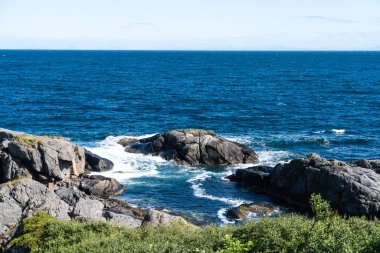 The deep blue Ocean with waves crashing on a rocky island. rugged, rocky coastline at the Sea. Atlantic Ocean coastline with rugged high cliffs. Pacific Ocean rocky coast scenery