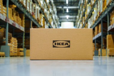 Tallinn, Estonia, 23.10.2023. Ikea cardboard box on warehouse floor, compact and ready for delivery and assembly. Ikea warehouse store interior, goods ready for pickup. clipart