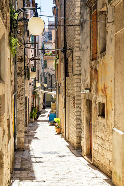 Small narrow alley in the old town of sibenik in croatia. Sibenik / Tourist city by the Adratic sea - Sibenik, Croatia.