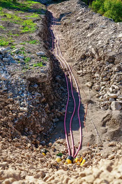 Laying High-Voltage Cables Underground Through the Forest to Connect Wind Turbines to the Power Grid.