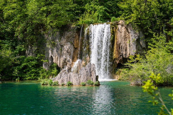 Tranquil Oasis: A stunning view of waterfalls amidst lush greenery in Krka National Park, showcasing Croatias natural beauty and tranquility. Perfect for travel and nature concepts.