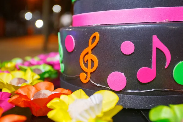 neon-themed cake with musical icons at a party in Rio de Janeiro, Brazil.
