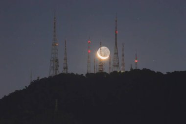 Moonset on the Sumare antennas in Rio de Janeiro, Brazil. clipart