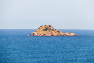 view of the middle island on the beach of sao conrado in rio de janeiro, brazil. clipart