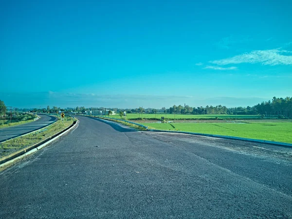 09.16.2023. Raiganj West Bengal India View of national highway through farmland
