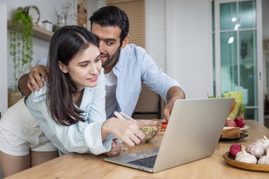 Mutfakta dijital tablet kullanan çift.