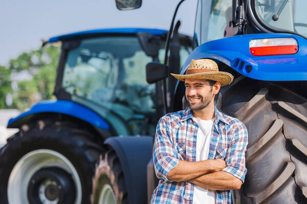 farmer standing in front of tractor
