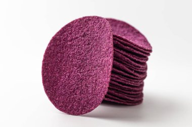 Purple sweet potato chips on a white background