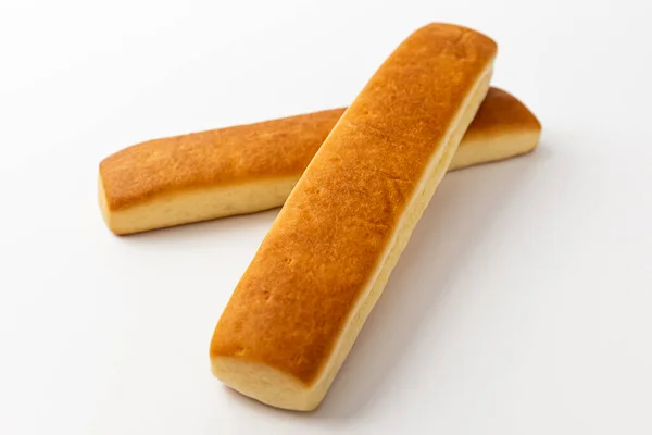 パンは白い背景にバターでスティック — ストック写真