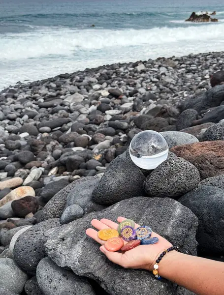 Hand Holding Chakra Healing Stones Glass Crystal Ball Volcanic Ocean — Stock Photo, Image