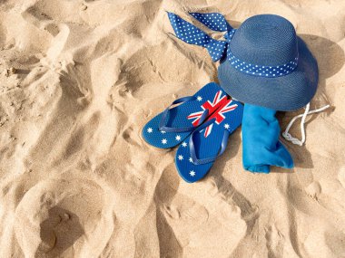 Beach Accessories on Sand - Hat, Flip Flops, Bag, and Shells for Summer Vacation. clipart