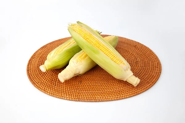 raw corn maize cob closeup isolated on white background