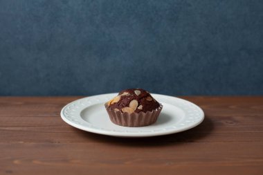 chocolate cupcake muffin isolated on wooden table