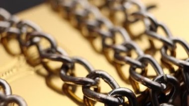 Close up of metal chain links conveying the message of power or entrapment