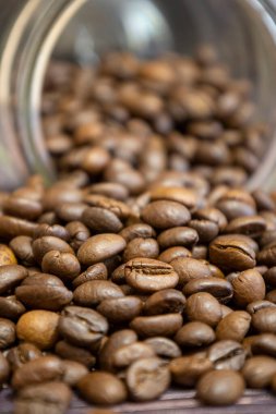 Cam kavanozdan dökülmüş kahve çekirdekleri..