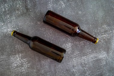 Two bottles of beer on a gray background