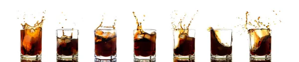 Many glasses of cola with splash and ice cubes on white