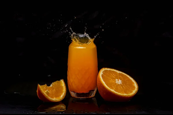 Splashes of orange juice on black.