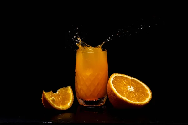 Splashes of orange juice on black.