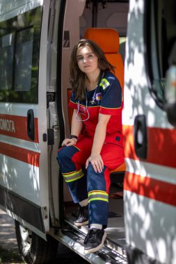 Arabanın yanında bir ambulans görevlisi var.