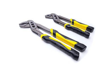 Two slip joint pliers with ergonomic yellow and black handles lying on a white background, ready for gripping and turning clipart