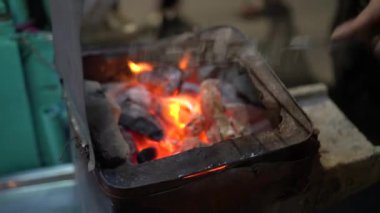 Seller preparing dry squids for grilling on street side of Thailand snack famous street food with charcoal roast