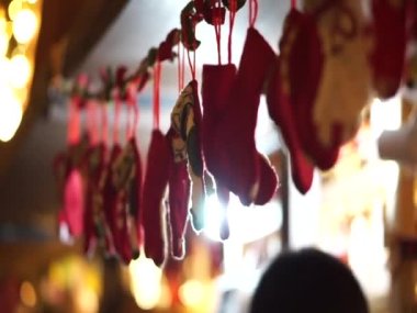 Christmas market vibe red socks hanging over stall front Santa Clause and gift concept background