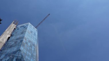 Skycraper city high rise glass building construction site with crane