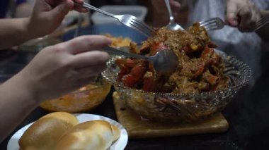 Singapur yengeci yiyen aile ev yapımı yemek imzalı yemek ve kızarmış ekmek ekmeği.