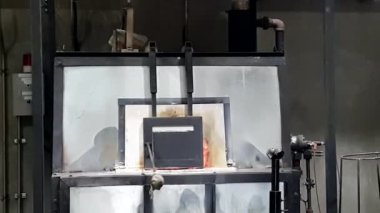 Stüdyo cam fırını, cam patlatan görkemli bir delik açıyor. Camları ateşle eritmek için yüksek sıcaklıkta ısıtılıyor.