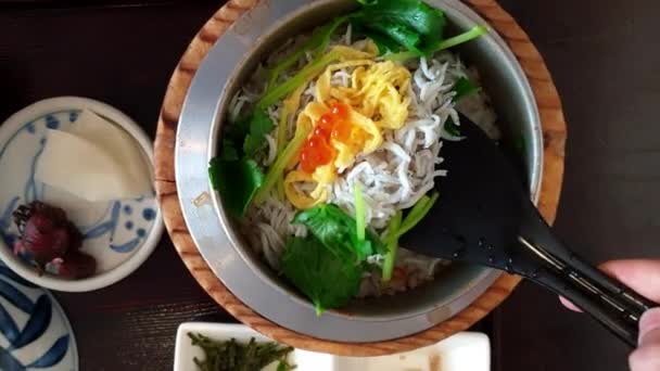 釜めし小魚米サイドディッシュ漬物付き日本の焼き鍋ご飯とお茶の伝統的なセット食品 — ストック動画