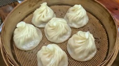 Elleri çubuklu Xiaolongbao çorbası yiyen Çin yemeği.