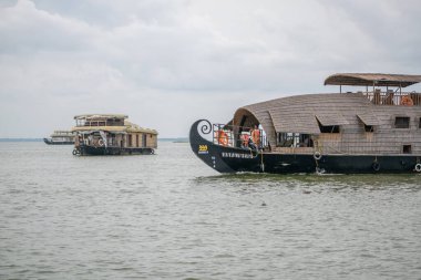 two big houseboats are surfing through backwater in Alappuzha Alleppey Kerala clipart