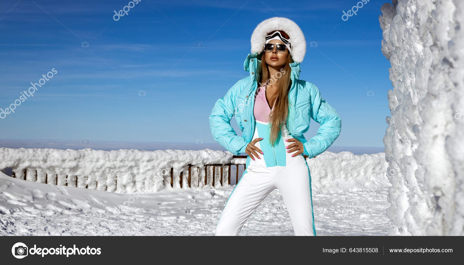 Winter fashion. Beautiful female model is wearing white winter