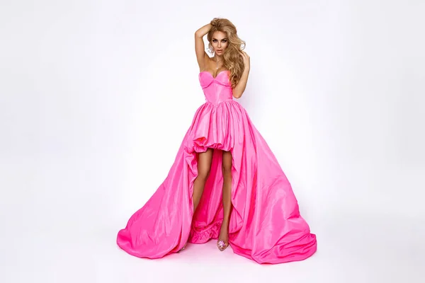 白い背景にエレガントなピンクの長いドレスでシックなブロンドの女性 豪華な夜のファッション グラマーとエレガンス — ストック写真