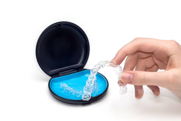 stock image Transparent aligners and storage case. Invisible braces. Clear teeth straighteners. plastic bracers ready to use