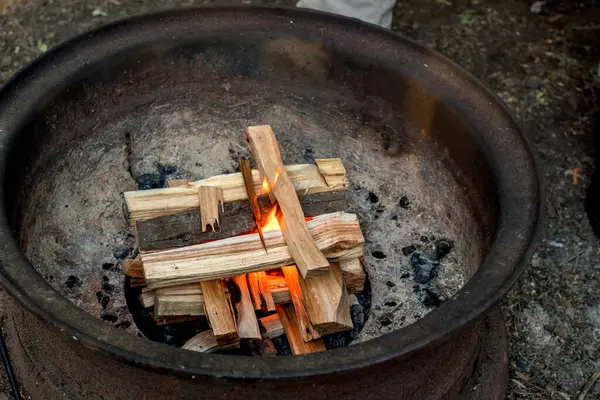 Yakacak odun ateşiyle bir kamp ateşi yakmak. Kamp yaşam tarzı.