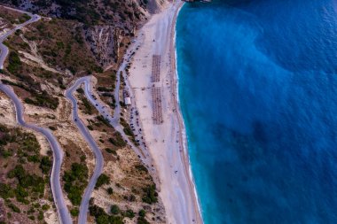 Kefalonia 'daki Myrtos Sahili büyüleyici turkuaz suları, beyaz çakıl taşları ve dik uçurumlarıyla bilinen nefes kesici bir kıyı bölgesi. Bu ikonik plaj yüzmek ve dinlenmek için ideal bir ortam sunuyor.