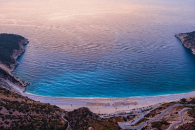 Myrtos Beach in Kefalonia is a breathtaking coastal destination known for its stunning turquoise waters, white pebbles, and steep cliffs. This iconic beach offers a serene setting ideal for swimming and relaxation clipart