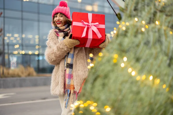 Kışın Giyinmiş Neşeli Genç Bir Kadın Alışveriş Merkezinin Yanında Hediye — Stok fotoğraf