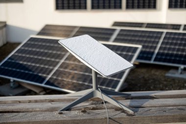 LVIV, UKRAINE - January, 2023: Starlink satellite dish, internet constellation operated by SpaceX, installed on roof of residential building equipped with solar panels
