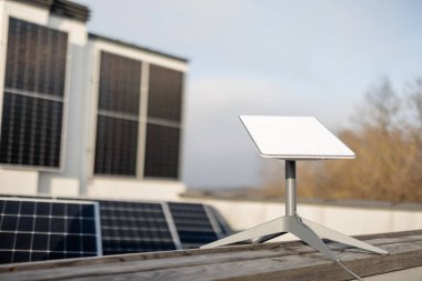 LVIV, UKRAINE - January, 2023: Starlink satellite dish, internet constellation operated by SpaceX, installed on roof of residential building equipped with solar panels