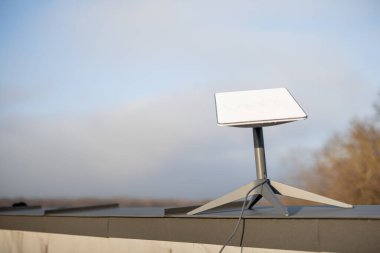LVIV, UKRAINE - January, 2023: Starlink satellite dish, internet constellation operated by SpaceX, installed on roof of residential building on sunny day
