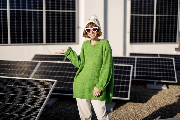 Woman Green Sweater Winter Hat Stands Rooftop Her House Solar — Stok fotoğraf